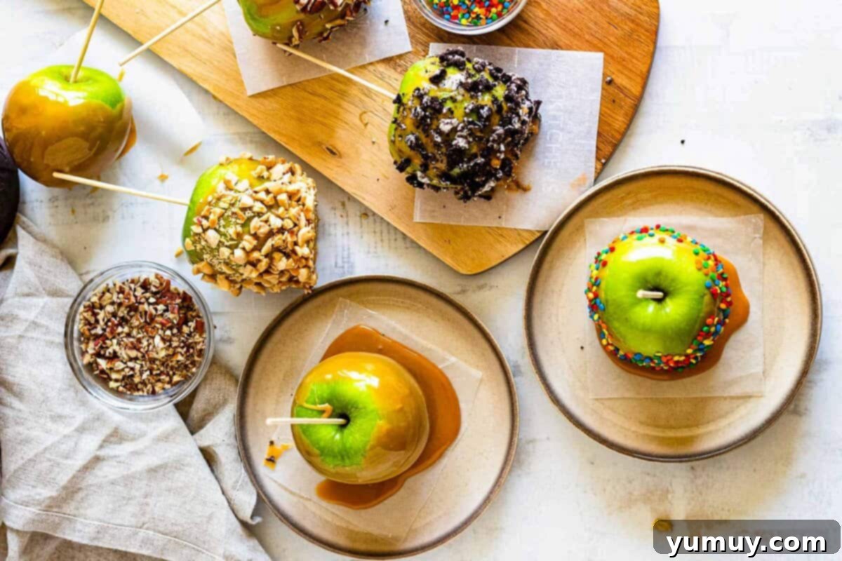 Overhead view of several beautifully decorated caramel apples on plates, ready for serving.