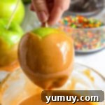 Dipping apples into melted caramel and rolling in toppings.
