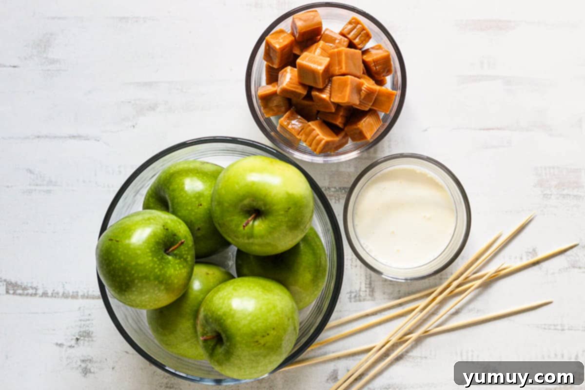 Cleaned and prepared apples on a surface, ready for the next steps in making caramel apples.