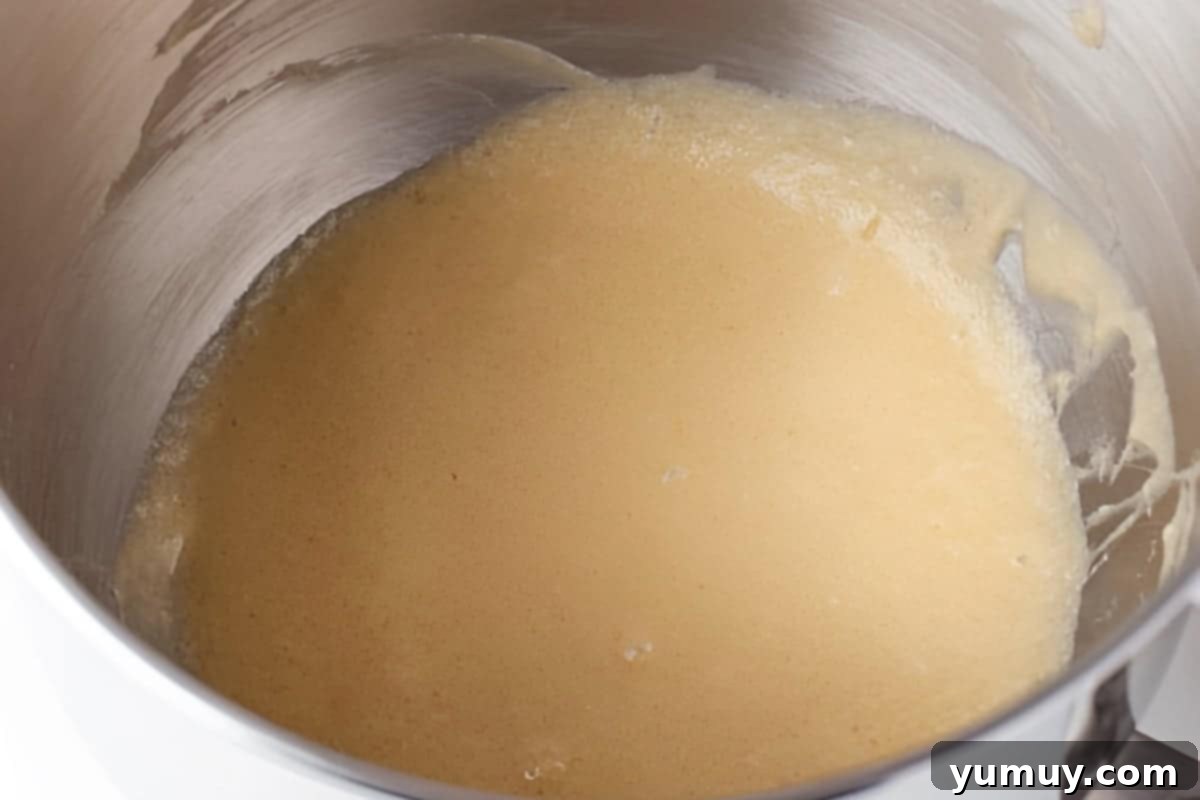 Raspberry Bliss Blondies 7 Creamed butter, sugar, eggs, and vanilla in a stand mixer bowl, showcasing the smooth and even consistency.